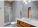 Clean bathroom with glass-enclosed shower, wood vanity, and a well-lit mirror at 5372 Bay Harbor Dr, Indianapolis, IN 46254