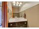 Half bathroom featuring a black vanity, chrome fixtures, and vanity lighting at 5372 Bay Harbor Dr, Indianapolis, IN 46254