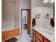 Well-lit bathroom featuring a tiled floor, a bathtub, and a vanity with a sink at 5372 Bay Harbor Dr, Indianapolis, IN 46254