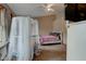 Cozy bedroom featuring a crib with sheer canopy, comfortable bed, and ceiling fan at 5372 Bay Harbor Dr, Indianapolis, IN 46254
