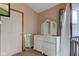 Bright bedroom featuring a white dresser with mirror and a window with sheer curtains at 5372 Bay Harbor Dr, Indianapolis, IN 46254