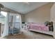 Bright, airy bedroom with a canopy crib and twin bed with neutral color walls at 5372 Bay Harbor Dr, Indianapolis, IN 46254