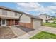 View of home's exterior displaying the front door, brickwork, siding, and well-kept lawn at 5372 Bay Harbor Dr, Indianapolis, IN 46254