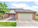 Charming townhouse with a brick facade and attached two-car garage, plus well-maintained landscaping at 5372 Bay Harbor Dr, Indianapolis, IN 46254
