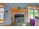 Close-up of the fireplace featuring a wooden mantel and decorative screen at 5372 Bay Harbor Dr, Indianapolis, IN 46254