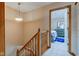 Upstairs hallway showcases wooden banister and leads to a carpeted bedroom at 5372 Bay Harbor Dr, Indianapolis, IN 46254