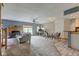 Spacious living room featuring a fireplace, fan, dining area, and bar area at 5372 Bay Harbor Dr, Indianapolis, IN 46254