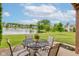 Patio seating offering peaceful views of a pond and community green space at 5372 Bay Harbor Dr, Indianapolis, IN 46254