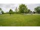 Large grassy backyard showcasing the expansive property, trees, and shed at 5388 W Hazelrigg Rd, Thorntown, IN 46071
