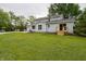 Expansive backyard featuring a well-maintained lawn, mature trees, and a charming light blue home exterior at 5388 W Hazelrigg Rd, Thorntown, IN 46071