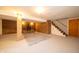 Unfinished basement space with wood burning stove and stairs to main floor at 5388 W Hazelrigg Rd, Thorntown, IN 46071