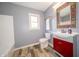Bathroom featuring modern vanity with a colorful framed mirror and vinyl floors at 5388 W Hazelrigg Rd, Thorntown, IN 46071