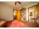 This bedroom shows hardwood floors, a bookshelf and a doorway leading to another room at 5388 W Hazelrigg Rd, Thorntown, IN 46071