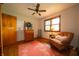 Cozy bedroom featuring a window, hardwood floors, a ceiling fan, and a charming area rug at 5388 W Hazelrigg Rd, Thorntown, IN 46071