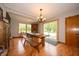 Bright dining area with a wooden table, bench seating, and natural light from large windows at 5388 W Hazelrigg Rd, Thorntown, IN 46071