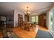 The dining room has a long wooden table and bench, complemented by natural light at 5388 W Hazelrigg Rd, Thorntown, IN 46071