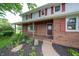 Welcoming front porch with brick accents and a charming entryway at 5388 W Hazelrigg Rd, Thorntown, IN 46071