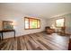 Cozy living room with wood-look floors, comfortable seating and natural light at 5388 W Hazelrigg Rd, Thorntown, IN 46071