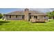 Brick house showcasing a well-manicured lawn and cozy back deck at 551 Windward Ln, Plainfield, IN 46168