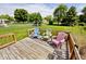 Wooden deck with colorful Adirondack chairs overlooking the backyard at 551 Windward Ln, Plainfield, IN 46168