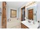 Bright bathroom with a soaking tub, vanity with sink, and natural wood accents at 551 Windward Ln, Plainfield, IN 46168