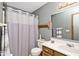 Compact bathroom featuring a shower with a patterned curtain and classic fixtures at 551 Windward Ln, Plainfield, IN 46168