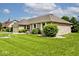 Brick home with a well-manicured lawn, attached garage, and mature trees, with an American flag at 551 Windward Ln, Plainfield, IN 46168