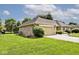 Brick home with a well-manicured lawn, attached garage, and mature trees at 551 Windward Ln, Plainfield, IN 46168