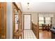 Well-lit hallway with tiled floor, coat rack, and view to the home's front entrance at 551 Windward Ln, Plainfield, IN 46168