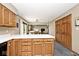 Kitchen island with white countertop and oak cabinets, adjacent to dining area at 551 Windward Ln, Plainfield, IN 46168
