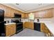 Well-lit kitchen with updated appliances, oak cabinetry and white countertops at 551 Windward Ln, Plainfield, IN 46168