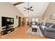 Inviting living room features vaulted ceilings, ceiling fan, and comfortable gray sofas at 551 Windward Ln, Plainfield, IN 46168