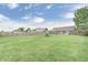 Expansive backyard featuring lush green grass, a wooden fence, and a swing set, offering ample space for recreation at 555 Echo Bend Blvd, Greenwood, IN 46142