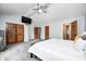 Bedroom features gray carpet, wooden doors, ceiling fan and a mounted tv on the wall at 555 Echo Bend Blvd, Greenwood, IN 46142