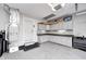 Spacious garage featuring ample cabinet storage, epoxy flooring, and a well-organized layout, enhancing functionality at 555 Echo Bend Blvd, Greenwood, IN 46142