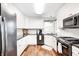 Well-lit kitchen featuring white cabinetry, dark countertops, and modern appliances at 555 Echo Bend Blvd, Greenwood, IN 46142