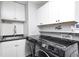 Modern laundry room with white cabinets, subway tile backsplash, and new front load washer and dryer machines at 555 Echo Bend Blvd, Greenwood, IN 46142