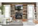 Cozy fireplace area complemented by wood accent wall and French doors to back yard at 555 Echo Bend Blvd, Greenwood, IN 46142