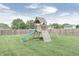 A colorful swing set with a slide, climbing wall, and a tire swing offers fun and entertainment for  at 555 Echo Bend Blvd, Greenwood, IN 46142