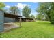 Expansive green backyard featuring covered porch, mature trees, and an outbuilding at 6348 W 750 N, McCordsville, IN 46055