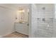 A well-lit bathroom featuring a double vanity, granite countertops, and a step-in shower with white tile at 6348 W 750 N, McCordsville, IN 46055