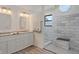 A gorgeous bathroom showcasing a double vanity, tile walls, and a walk-in shower with a small window at 6348 W 750 N, McCordsville, IN 46055