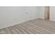 A bright bedroom with wood-look floors, white walls, and a white door on display at 6348 W 750 N, McCordsville, IN 46055