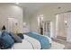 Bright bedroom showing a kitchenette, white trim, and a sliding door to the bathroom at 6348 W 750 N, McCordsville, IN 46055