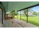 Long covered porch with wood flooring and posts overlooking the expansive yard at 6348 W 750 N, McCordsville, IN 46055
