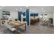 Open-concept dining room with modern light fixtures, chairs, and the kitchen with blue cabinets at 6348 W 750 N, McCordsville, IN 46055