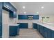 Modern kitchen with stylish blue cabinetry, white subway tile backsplash, and stainless steel microwave at 6348 W 750 N, McCordsville, IN 46055