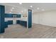 Modern kitchen featuring blue cabinets, a subway tile backsplash, and an open layout concept at 6348 W 750 N, McCordsville, IN 46055