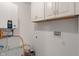 Laundry room featuring white cabinets, a hot water heater, and utility connections at 6348 W 750 N, McCordsville, IN 46055