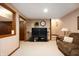 Finished basement with striped wallpaper, a sofa and television for a warm living space at 6575 Robin Hood Dr, Indianapolis, IN 46227